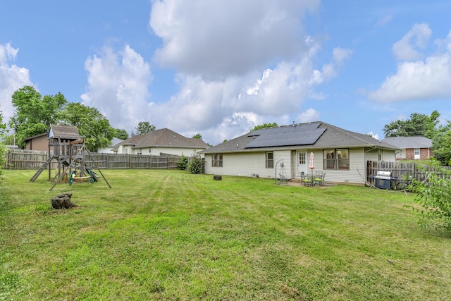 676 E Gallup Hill Rd, Nixa, MO 65714 - back of property with a playground, solar panels, a patio, and a fenced backyard