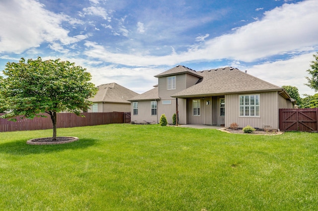 276 Steury Rd, Springfield, MO 65809 - rear view of property featuring a fenced backyard, a shingled roof, and a patio area