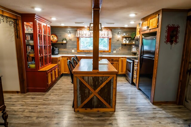 1950 N Crossway Rd, Fair Grove, MO 65648 - kitchen featuring open shelves, stainless steel appliances, butcher block counters, light wood-type flooring, and a kitchen island