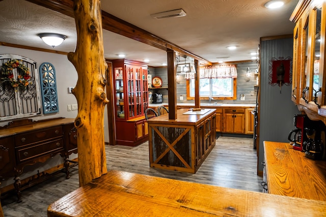1950 N Crossway Rd, Fair Grove, MO 65648 - kitchen featuring wooden counters, light wood finished floors, decorative columns, recessed lighting, and crown molding