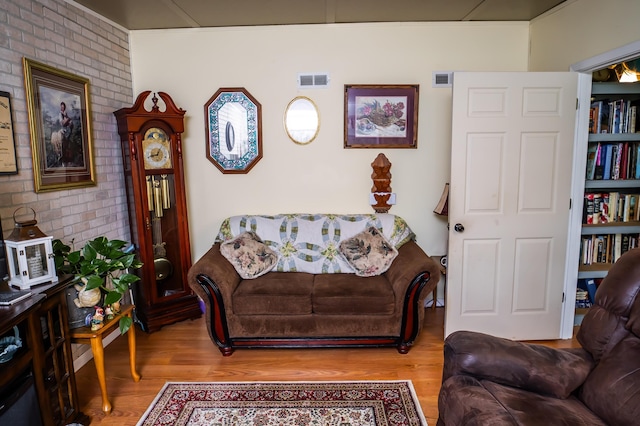 1950 N Crossway Rd, Fair Grove, MO 65648 - living area with wood finished floors and brick wall
