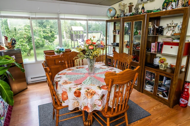 1950 N Crossway Rd, Fair Grove, MO 65648 - dining area with a baseboard radiator, wood finished floors, and plenty of natural light