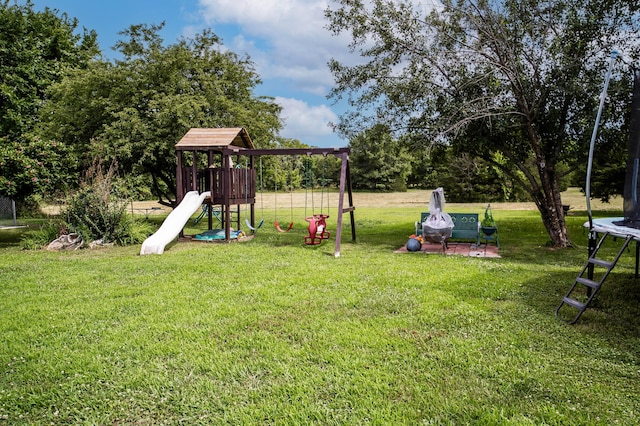 1950 N Crossway Rd, Fair Grove, MO 65648 - view of play area featuring a trampoline and a lawn