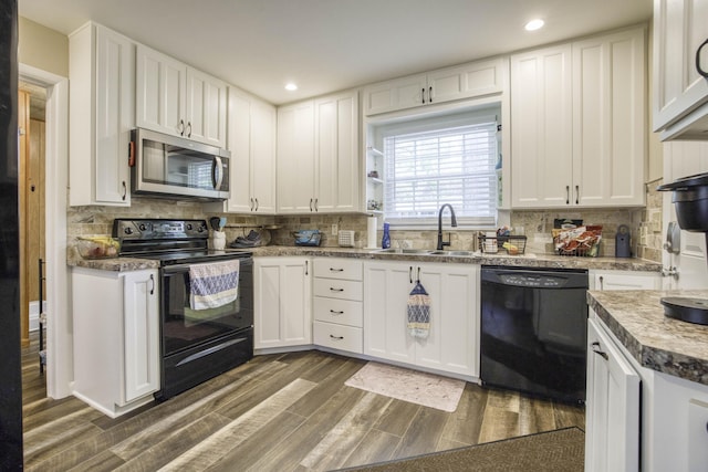 1650 S Fort Ave, Springfield, MO 65807 - kitchen featuring black appliances, white cabinets, dark wood-style flooring, and recessed lighting