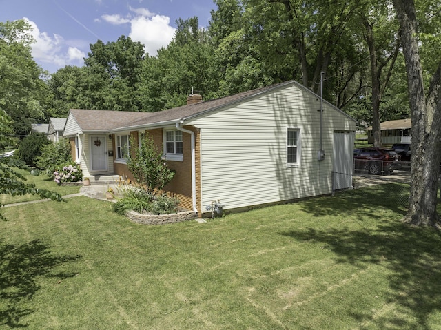 1650 S Fort Ave, Springfield, MO 65807 - view of side of property with a chimney, a yard, and brick siding