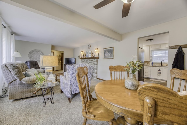 1650 S Fort Ave, Springfield, MO 65807 - dining space with light colored carpet, ceiling fan, and beam ceiling