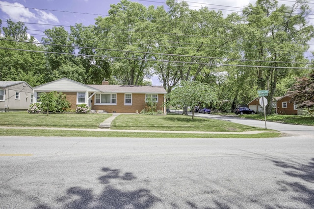 1650 S Fort Ave, Springfield, MO 65807 - ranch-style house featuring a chimney, brick siding, and a front lawn