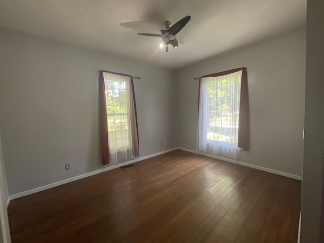 630 W State St, Springfield, MO 65806 - spare room featuring plenty of natural light, dark wood-type flooring, and ceiling fan