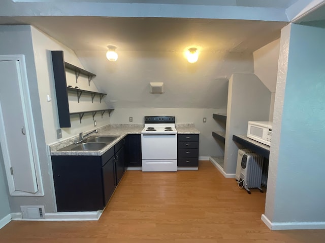 630 W State St, Springfield, MO 65806 - kitchen with white appliances, open shelves, light wood finished floors, dark cabinets, and light countertops