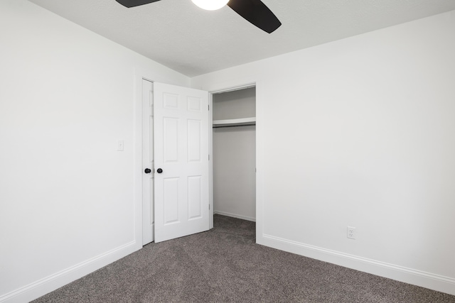 4959 S Mccann Ave, Springfield, MO 65804 - unfurnished bedroom featuring dark carpet, a closet, and a ceiling fan