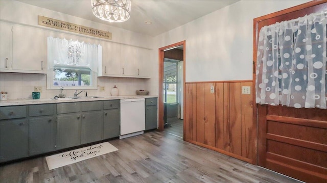 1931 Kay Dr, West Plains, MO 65775 - kitchen featuring dishwasher, healthy amount of natural light, light wood-style floors, a wainscoted wall, and light countertops
