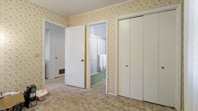 1931 Kay Dr, West Plains, MO 65775 - unfurnished bedroom featuring wallpapered walls, crown molding, carpet floors, and a closet