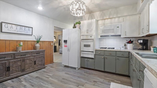 1931 Kay Dr, West Plains, MO 65775 - kitchen with white appliances, a warming drawer, gray cabinets, light wood-type flooring, and light countertops
