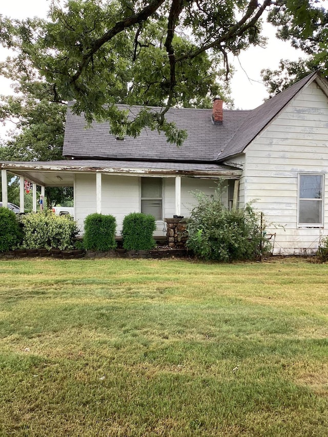 1231 W Main St, Fordland, MO 65652 - back of property featuring a chimney, a yard, and roof with shingles