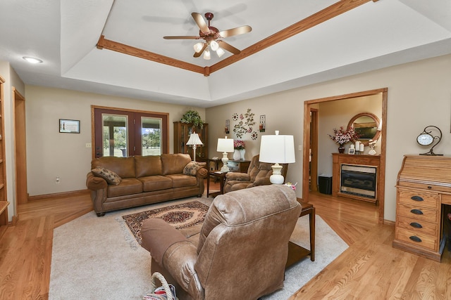 615 W Mchenry Ave, Billings, MO 65610 - living area featuring ceiling fan, a fireplace, light wood-style floors, and a raised ceiling
