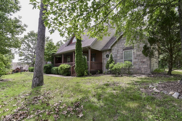 613 Crossing Dr, Branson West, MO 65737 - view of front of property with stone siding, a porch, a front yard, and roof with shingles
