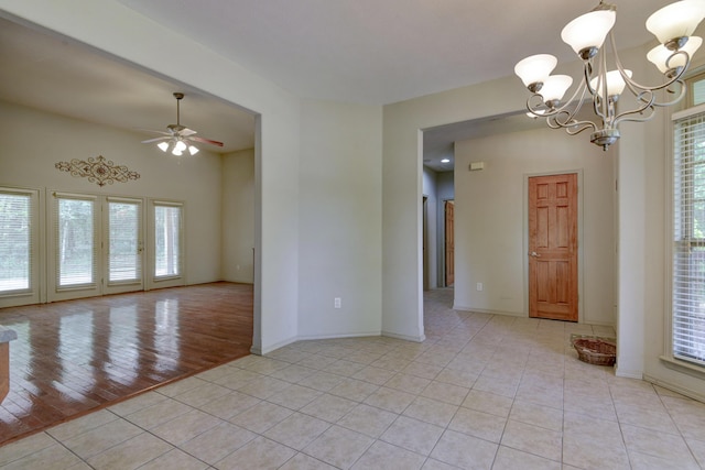613 Crossing Dr, Branson West, MO 65737 - unfurnished room with a chandelier, light tile patterned flooring, and a ceiling fan