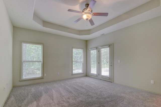 613 Crossing Dr, Branson West, MO 65737 - carpeted empty room with plenty of natural light, a ceiling fan, and a raised ceiling