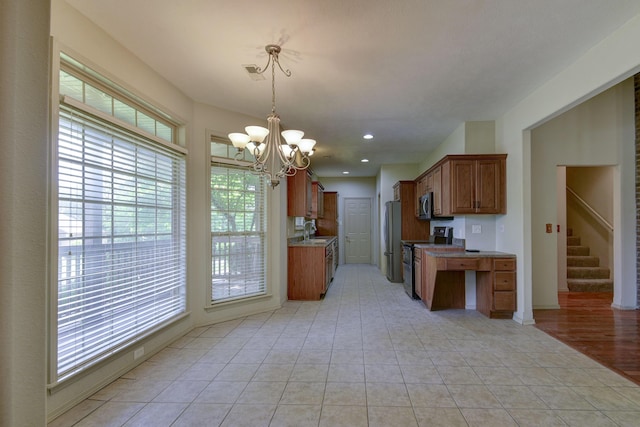 613 Crossing Dr, Branson West, MO 65737 - kitchen featuring stainless steel appliances, brown cabinets, healthy amount of natural light, a chandelier, and recessed lighting