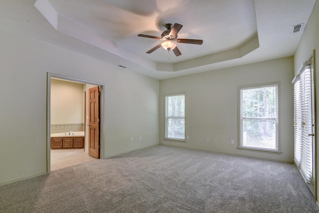 613 Crossing Dr, Branson West, MO 65737 - unfurnished room with light carpet, ceiling fan, healthy amount of natural light, and a tray ceiling