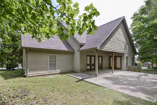 613 Crossing Dr, Branson West, MO 65737 - back of house featuring roof with shingles, a patio area, and a lawn