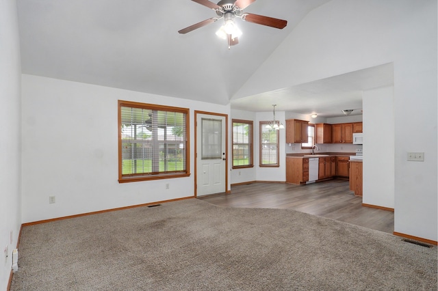 409 Ace Ct, Nixa, MO 65714 - unfurnished living room featuring carpet flooring, a chandelier, a ceiling fan, and high vaulted ceiling