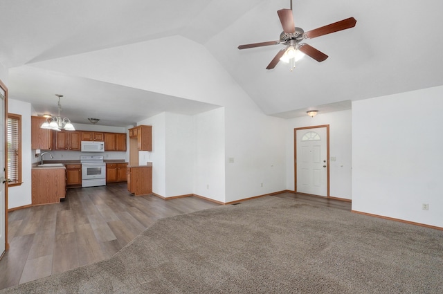 409 Ace Ct, Nixa, MO 65714 - unfurnished living room with a chandelier, high vaulted ceiling, a ceiling fan, and dark wood-style flooring