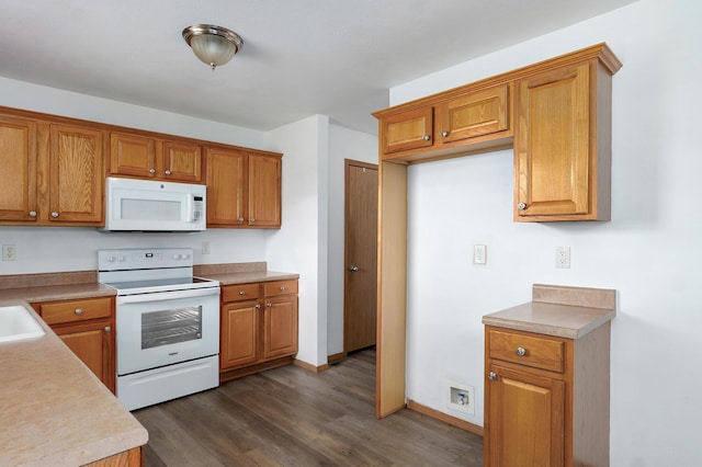 409 Ace Ct, Nixa, MO 65714 - kitchen featuring white appliances, dark wood-style floors, brown cabinetry, and light countertops