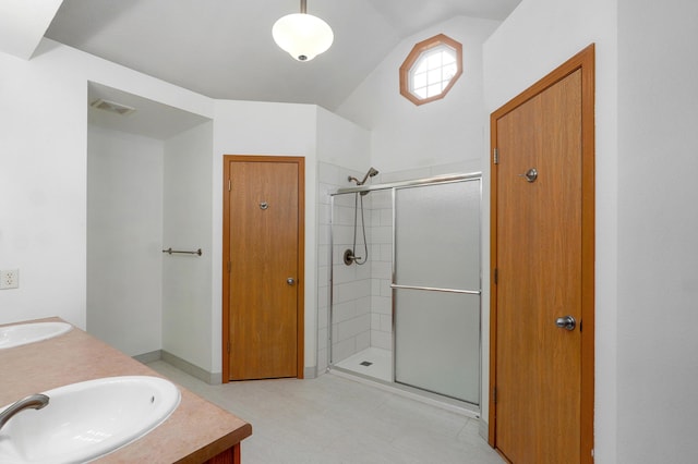 409 Ace Ct, Nixa, MO 65714 - bathroom featuring vaulted ceiling, a stall shower, and double vanity