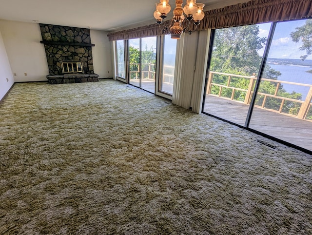 55 Cricket Hill Ln, Lampe, MO 65681 - unfurnished living room with a chandelier, carpet, a water view, and a fireplace