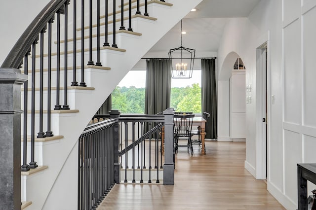 1373 E River Oak Dr, Springfield, MO 65803 - stairway with wood finished floors, a chandelier, arched walkways, and recessed lighting