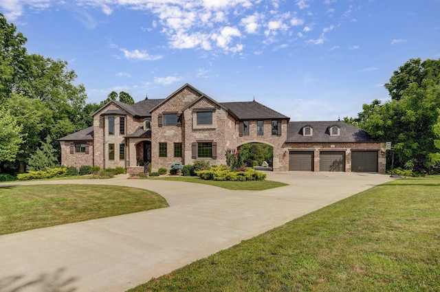 1373 E River Oak Dr, Springfield, MO 65803 - french country home with driveway, brick siding, and a front yard