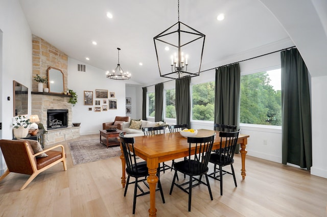 1373 E River Oak Dr, Springfield, MO 65803 - dining area featuring light wood-type flooring, a fireplace, a chandelier, recessed lighting, and high vaulted ceiling