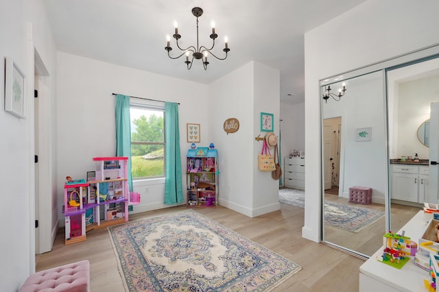 1373 E River Oak Dr, Springfield, MO 65803 - recreation room with a chandelier and light wood-style floors