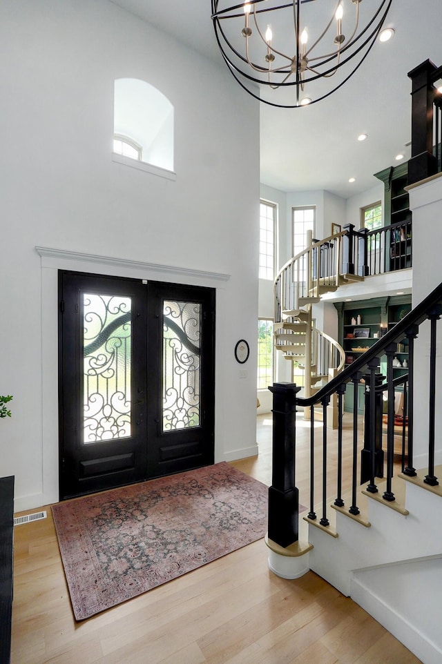 1373 E River Oak Dr, Springfield, MO 65803 - foyer with stairs, wood finished floors, a chandelier, a high ceiling, and french doors