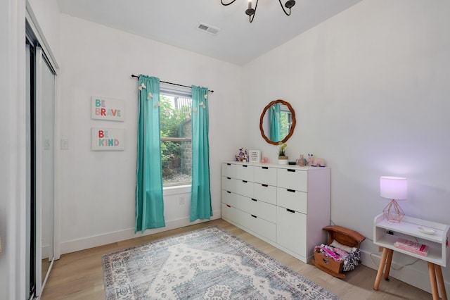 1373 E River Oak Dr, Springfield, MO 65803 - bedroom featuring light wood-style flooring and a chandelier