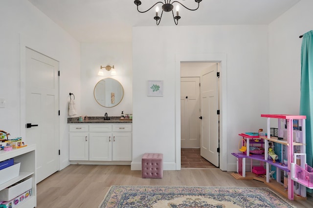 1373 E River Oak Dr, Springfield, MO 65803 - bathroom featuring wood finished floors, vanity, and a chandelier