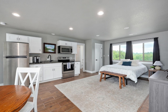 1373 E River Oak Dr, Springfield, MO 65803 - bedroom featuring freestanding refrigerator, dark wood finished floors, and recessed lighting