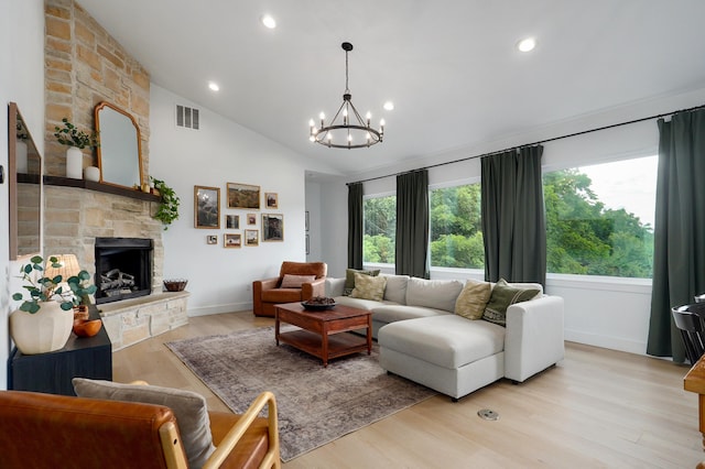 1373 E River Oak Dr, Springfield, MO 65803 - living area featuring a stone fireplace, light wood finished floors, a chandelier, recessed lighting, and vaulted ceiling