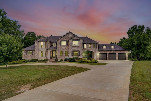 1373 E River Oak Dr, Springfield, MO 65803 - french country style house with driveway, a front yard, an attached garage, and brick siding