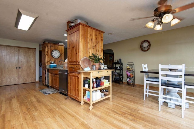 637 State Highway Kk, Cedar Creek, MO 65627 - kitchen with dishwasher, ceiling fan, light wood-style floors, arched walkways, and brown cabinets