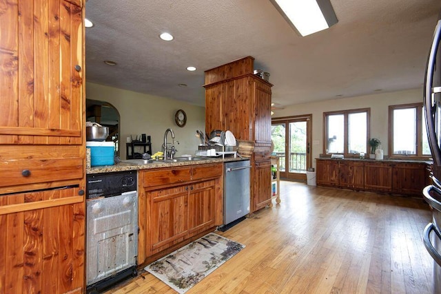 637 State Highway Kk, Cedar Creek, MO 65627 - kitchen with dishwasher, light wood-style flooring, recessed lighting, brown cabinetry, and light stone countertops