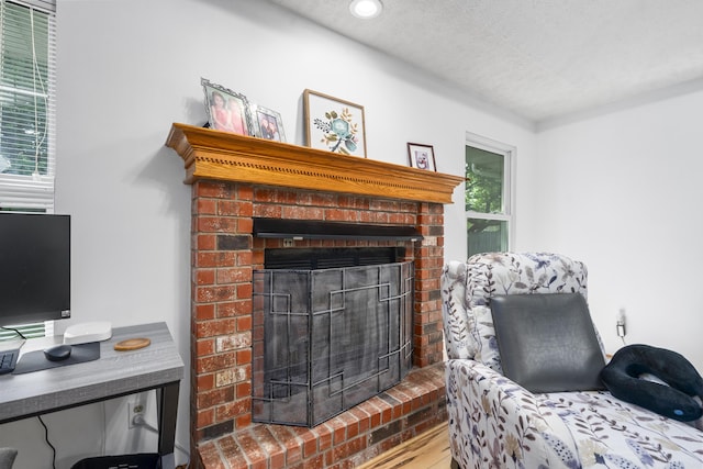 4105 S Oak Ave, Springfield, MO 65804 - living room with a brick fireplace, a textured ceiling, wood finished floors, and recessed lighting