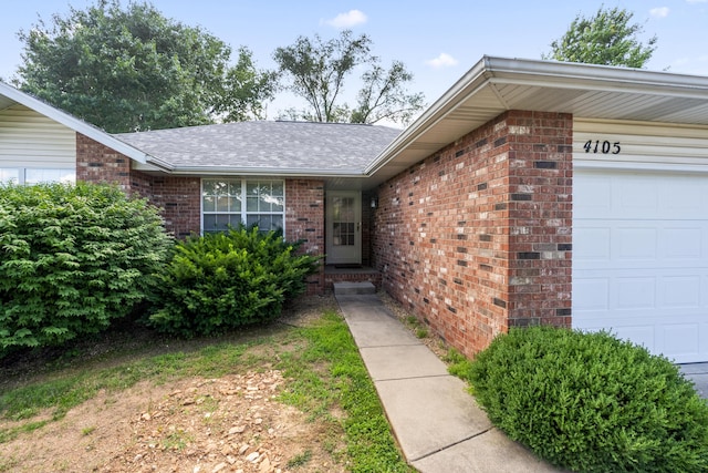 4105 S Oak Ave, Springfield, MO 65804 - entrance to property with an attached garage, brick siding, and roof with shingles