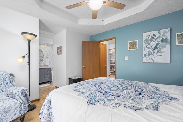 4105 S Oak Ave, Springfield, MO 65804 - bedroom with light wood-style flooring, a raised ceiling, and ceiling fan