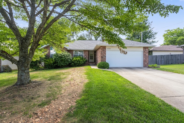 4105 S Oak Ave, Springfield, MO 65804 - view of front of house featuring brick siding, a garage, driveway, and a shingled roof