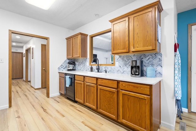4105 S Oak Ave, Springfield, MO 65804 - kitchen with dishwasher, decorative backsplash, brown cabinets, and light wood-style floors