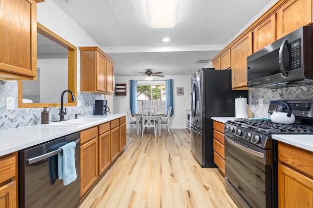 4105 S Oak Ave, Springfield, MO 65804 - kitchen with stainless steel range with gas cooktop, dishwasher, ceiling fan, tasteful backsplash, and a textured ceiling