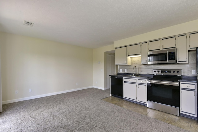 12 Scenic Ct Unit 10, Branson, MO 65616 - kitchen featuring stainless steel appliances, dark countertops, tasteful backsplash, a textured ceiling, and carpet flooring