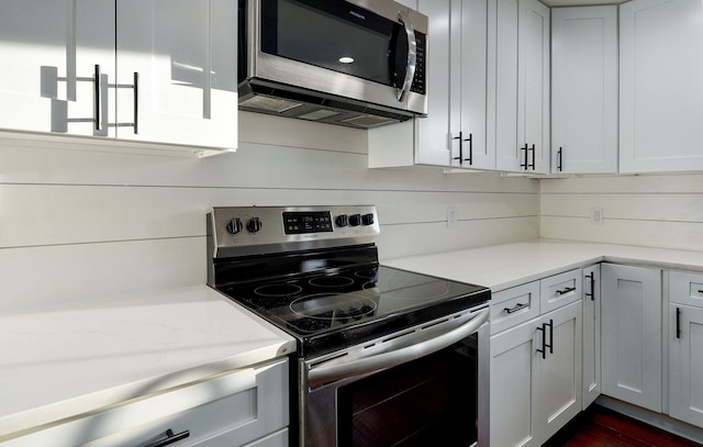 753 S Elm Rd, Marshfield, MO 65706 - kitchen with stainless steel appliances, dark wood-style flooring, and white cabinetry